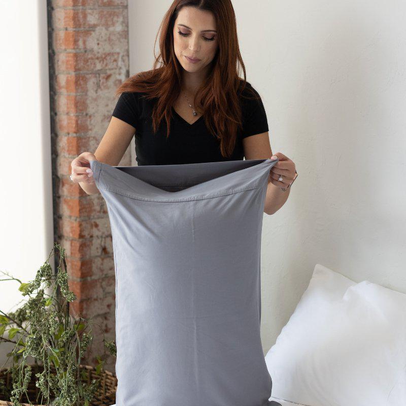 woman-putting-on-blue-pillow-case