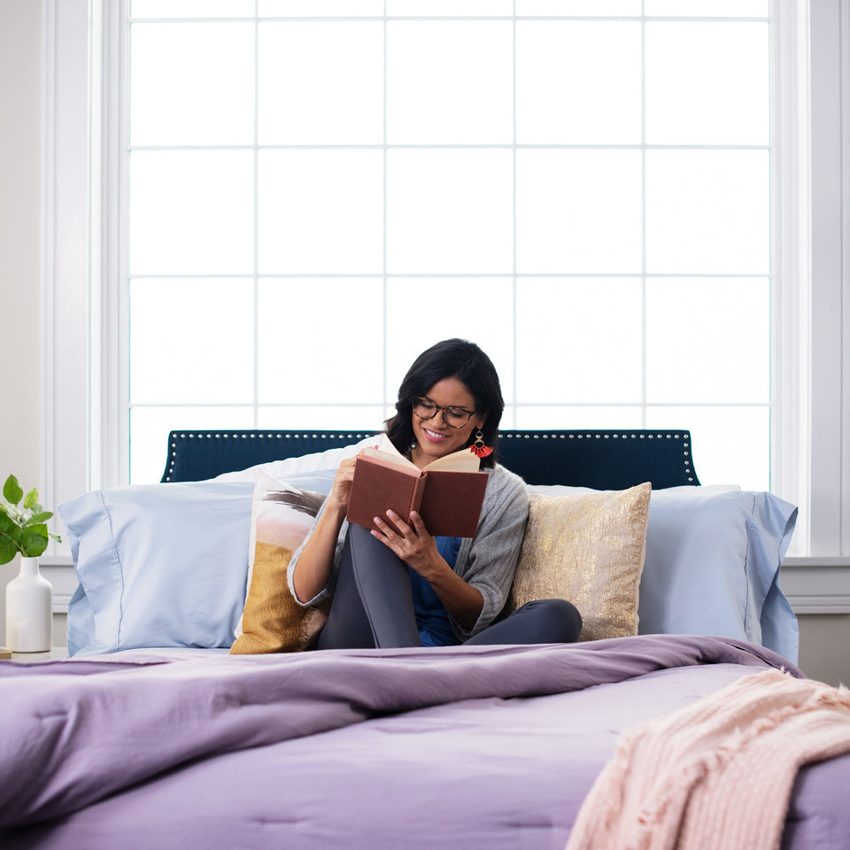 woman-laying-on-bed-with-pillows-collection